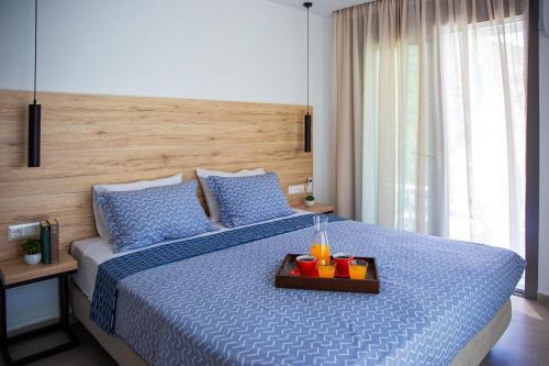 a bedroom with a bed with a tray of drinks on it at Adrianna Villa 1 in Balíon