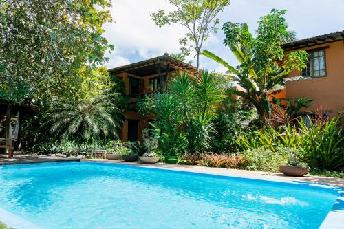 a swimming pool in front of a house at Pousada Erva Doce in Arraial d'Ajuda