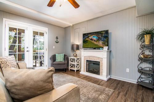 a living room with a couch and a fireplace at Cottages at Fair Haven Cove in Cape Fair