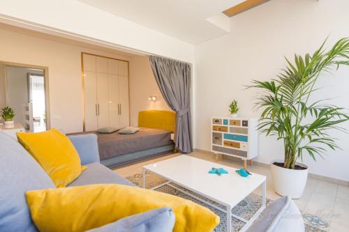 a living room with a couch and a bed at Apartamento - OASIS in Morro del Jable