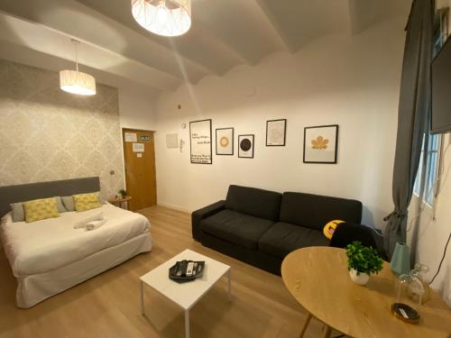 a living room with a couch and a table at Santa Ana´s Charming Flat in Madrid