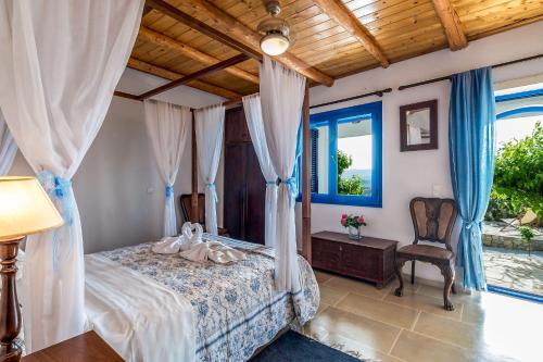 A bed or beds in a room at Villa Myrina with Sea View BY APOKORONAS-VILLAS