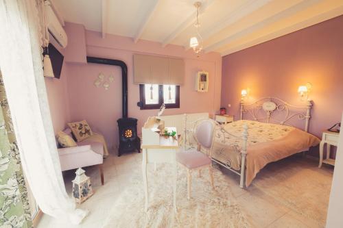 a bedroom with a bed and a table and a chair at Paroraia in Ángistron