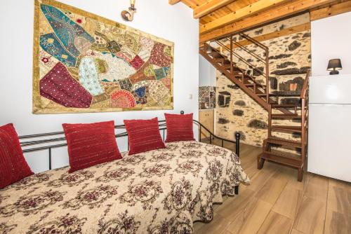 a bedroom with a bed with red pillows at Fairytale Elafonisi in Elafonisi