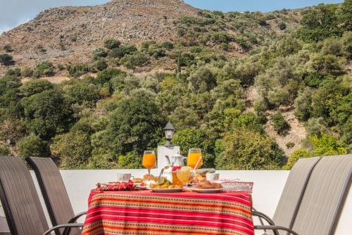 a table with food and drinks on top of a mountain at Fairytale Elafonisi in Elafonisi