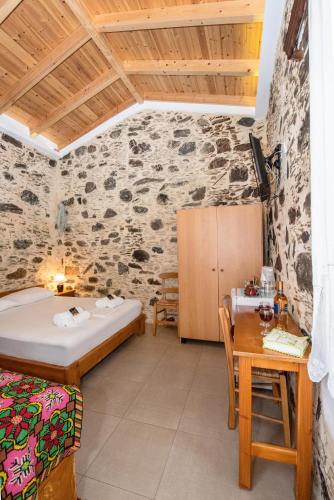 a bedroom with a bed and a table in a room at Fairytale Elafonisi in Elafonisi