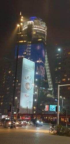 a city at night with a large building at Apartament Centrum Jana Pawła II in Warsaw