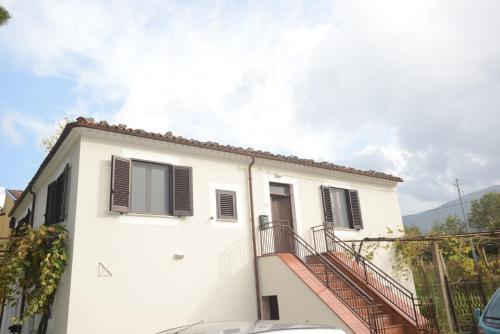 a white house with a staircase in front of it at Casetta Margret in Boiano