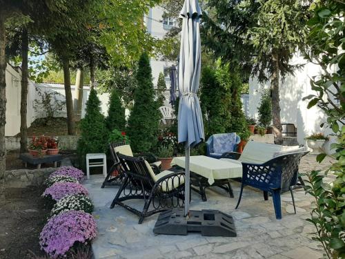 a patio with a table and chairs and an umbrella at Apartment Queen in Belgrade