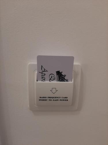 a cup on a wall with a sign on it at Apartment Queen in Belgrade