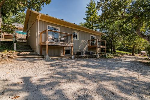 a house with a porch and a balcony at Cottages at Fair Haven Cove in Cape Fair