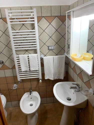 a bathroom with a sink and a toilet and a mirror at Vico d'Ercole in Fondi