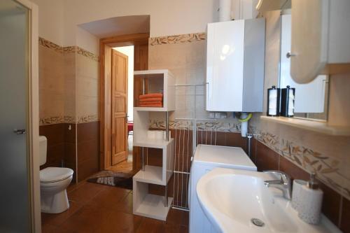 a bathroom with a sink and a toilet at Centrum Vendégház in Eger