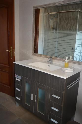 a bathroom with a sink and a mirror at MARIELI in Barakaldo