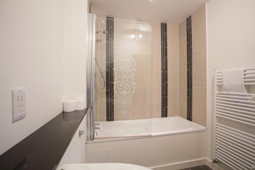 a bathroom with a shower and a toilet and a sink at Loch Ness Abbey Cottages in Fort Augustus