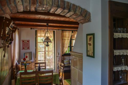 a kitchen and dining room with a table and chairs at Titi Family Apartman in Bük