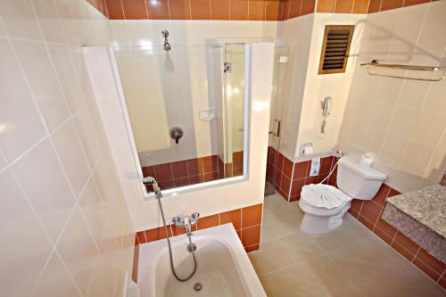 a bathroom with a shower and a toilet and a sink at Lek Villa in North Pattaya