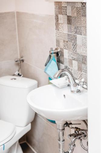 a bathroom with a sink and a toilet at Feierabend Elsdorf in Elsdorf