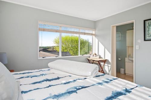 a bedroom with a large bed with a window at Maxwell's Golf Retreat in Bombay