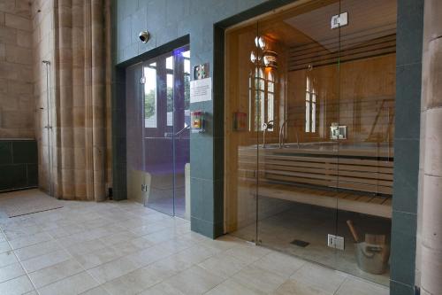a bathroom with a glass shower in a building at Loch Ness Abbey Cottages in Fort Augustus
