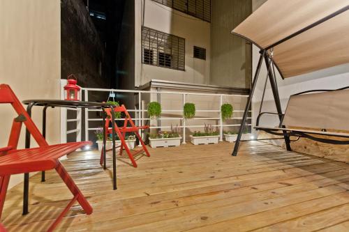 a balcony with a table and chairs and potted plants at Leo 111/Arena Ruifeng in Kaohsiung
