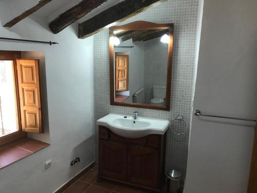 a bathroom with a sink and a mirror at B&B Cortijo El Ciruelo in Chirivel