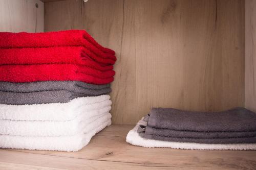 a group of towels are stacked on a wall at Dolce Casa in Belgrade