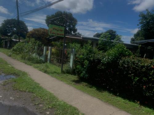 a sign for a restaurant on the side of a road at PaCasa Hostel in David
