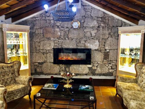a living room with a stone wall with a fireplace at Hotel Rural Vilaflor Self check in 24h in Vilaflor