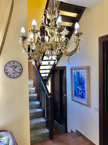 a chandelier in a hallway with a staircase at Hotel Rural Vilaflor Self check in 24h in Vilaflor