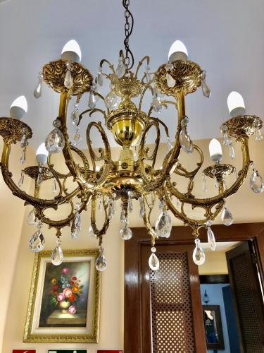 a gold chandelier hanging from a ceiling at Hotel Rural Vilaflor Self check in 24h in Vilaflor