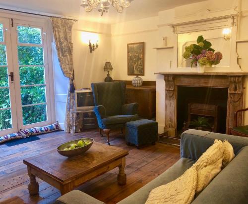 a living room with a couch and a fireplace at Lauras Townhouse Apartments Grand Garden Apartment in Bath