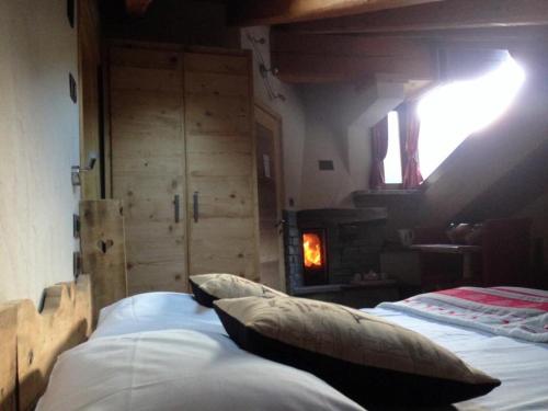 a bed in a room with a fire place at LTHorses & Dreams in La Thuile