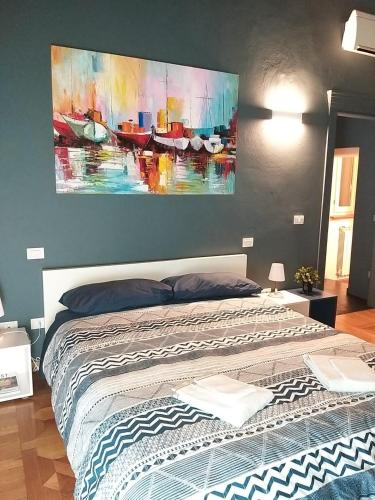 a bedroom with a bed with a painting on the wall at Modena Charme Sant'Eufemia in Modena