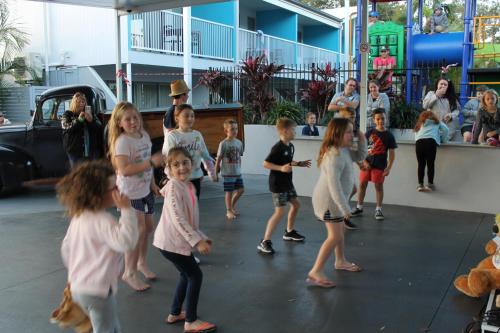 a group of children are dancing in a gym at Nobby Beach Holiday Village in Gold Coast