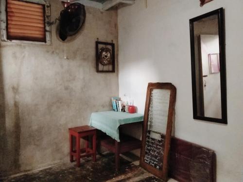 a room with a table and a mirror and a chair at Yez Yez Yez All Good Hostel in Yogyakarta
