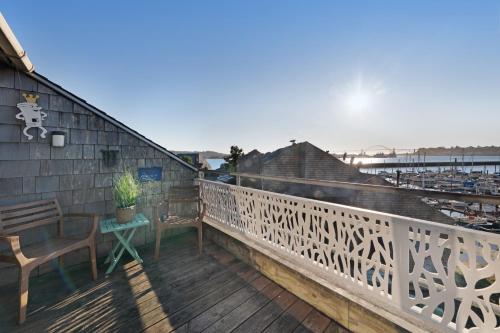 a balcony with a table and a chair on it at Embarcadero Bay View in Newport