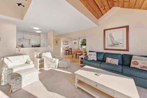 a living room with a blue couch and a table at Embarcadero Bay View in Newport