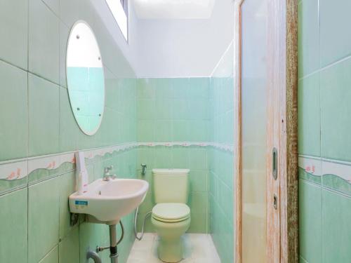 a bathroom with a toilet and a sink at Chendana Homestay Bali in Sanur