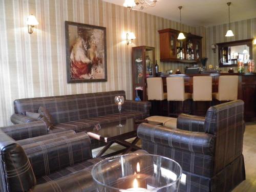 a living room with couches and a bar at Hagiati Anastasiou Hotel & Spa in Naousa Imathias