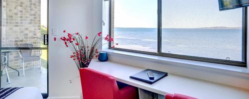 a room with a desk with a keyboard and a window at Limani Port Lincoln in Port Lincoln
