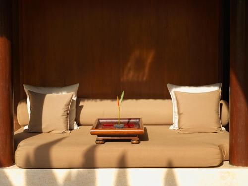 a bed with a tray with a plant on it at The Legian Seminyak, Bali in Seminyak