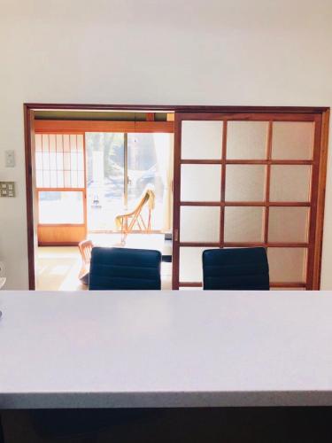 a room with a table and two blue chairs and a room with a table at STAY FUJI a in Yamanakako