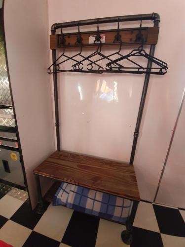 a wooden bench sitting in a corner of a room at Rose City Caravan Park in Warwick