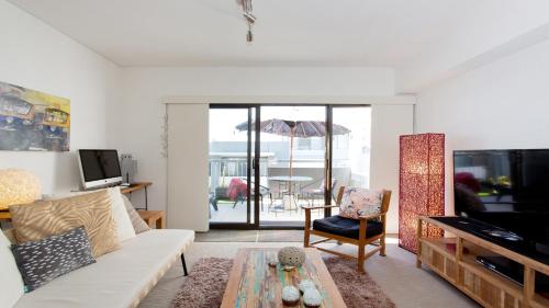 a living room with a couch and a table at Seabreeze - Coastal Living in Fremantle