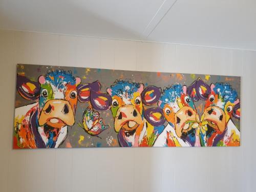 a painting of a group of cows on a wall at Rose City Caravan Park in Warwick
