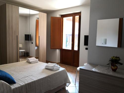a bedroom with a bed with two towels on it at B&B Villa Martina in Sardara