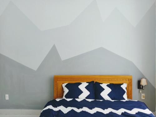 a bedroom with a bed with blue and white pillows at Ly Ly River in Hoi An