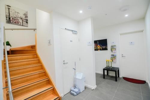 a staircase in a room with a stair case at U101 Brunswick Living First Floor Balcony Close to APT and CBD Free Wifi Tram at Doorstep in Melbourne