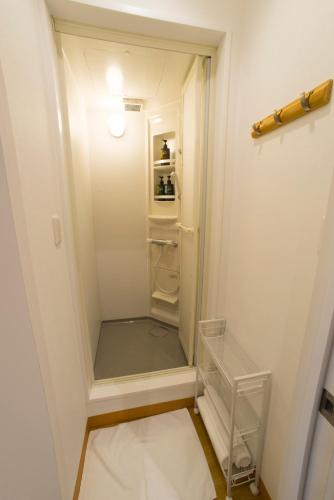 a small walk in closet with a refrigerator at HOSTEL SunTerrace Ishigaki in Ishigaki Island